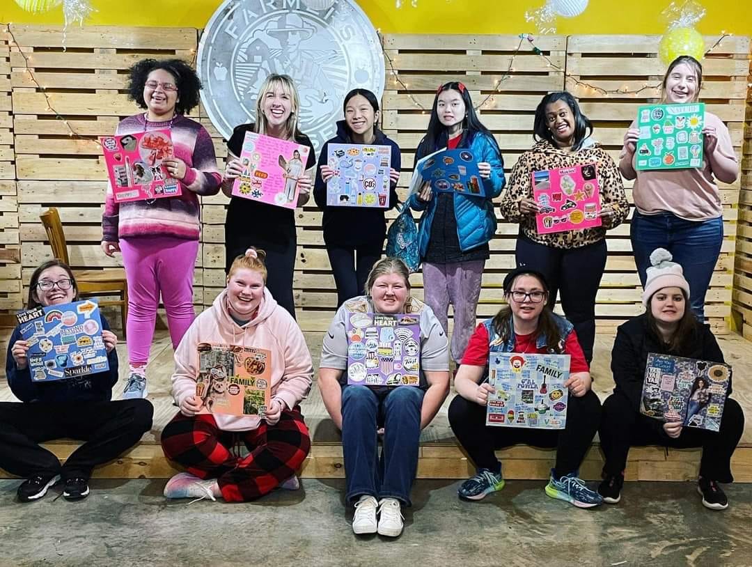 Group of students holding the art they made